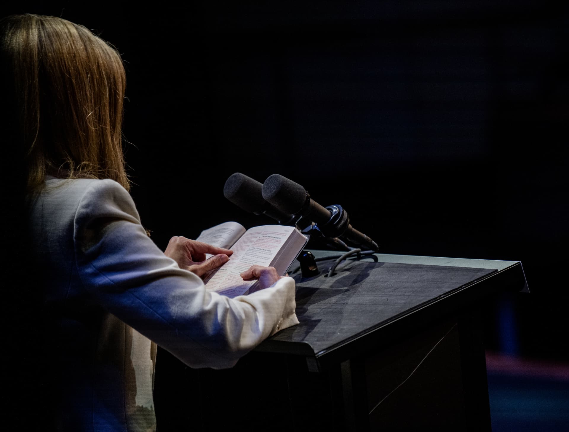 Jen Lilley reading from an open Bible at the America Reads the Bible lectern.